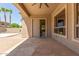 Covered patio showcases stone floors, ceiling fan, and offers outdoor lounging at 2453 E Ebony Dr, Chandler, AZ 85286