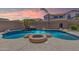Backyard pool and spa with rock waterfall feature and patio with fire pit at 2453 E Ebony Dr, Chandler, AZ 85286