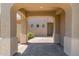 Covered entrance featuring brick floor, neutral paint, and views of the desert landscape at 2453 E Ebony Dr, Chandler, AZ 85286