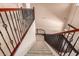 Staircase featuring carpeted steps, wrought iron railing, and high ceilings at 2453 E Ebony Dr, Chandler, AZ 85286