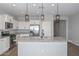 Modern kitchen with stainless steel appliances, granite countertops, kitchen island, and modern lighting at 25651 N 161St Ave, Surprise, AZ 85387