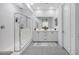 Modern bathroom with a glass-enclosed shower, double vanity, and neutral color scheme at 25658 N 140Th Ln, Surprise, AZ 85387