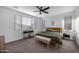 Comfortable bedroom featuring a ceiling fan, large window, and coordinated furniture set at 25658 N 140Th Ln, Surprise, AZ 85387
