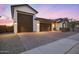 Charming single-story home with a three-car garage and stylish desert landscaping at 25658 N 140Th Ln, Surprise, AZ 85387