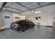Interior view of the car garage with epoxy floors and organized storage at 25658 N 140Th Ln, Surprise, AZ 85387