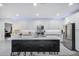 Bright kitchen with ample white cabinetry, stainless steel appliances, and a large island with seating at 25658 N 140Th Ln, Surprise, AZ 85387