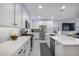 Modern kitchen features sleek white cabinetry, stainless steel appliances, and ample countertop space at 25658 N 140Th Ln, Surprise, AZ 85387