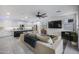Spacious living room and kitchen area with an open-concept design and modern appliances at 25658 N 140Th Ln, Surprise, AZ 85387