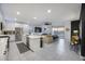Bright open-concept living space with a modern kitchen, comfortable seating, and outdoor views at 25658 N 140Th Ln, Surprise, AZ 85387