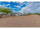 Spacious home on expansive lot with well-maintained grounds, partial fencing, and a serene desert landscape at 25723 S Hawes Rd, Queen Creek, AZ 85142
