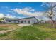 Spacious backyard with grassy lawn, concrete patio, brick path, and wooden fence at 25723 S Hawes Rd, Queen Creek, AZ 85142