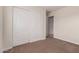 Bedroom featuring neutral carpet and paint with closet at 25723 S Hawes Rd, Queen Creek, AZ 85142