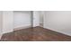 Bedroom featuring wood floors, a closet, and neutral paint at 25723 S Hawes Rd, Queen Creek, AZ 85142