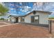 Inviting home exterior with landscaped front yard, shaded windows, and a secure front entry at 25723 S Hawes Rd, Queen Creek, AZ 85142