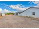 House exterior featuring a three-car garage, gravel landscaping, and durable siding for lasting curb appeal at 25723 S Hawes Rd, Queen Creek, AZ 85142