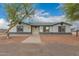 Charming single-story home with gray exterior, well-lit entry, and low-maintenance landscaping for a welcoming ambiance at 25723 S Hawes Rd, Queen Creek, AZ 85142
