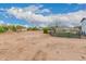 Expansive lot with a dirt yard, partial fencing, and desert landscape, ideal for outdoor activities and relaxation at 25723 S Hawes Rd, Queen Creek, AZ 85142