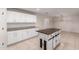 Bright, open kitchen features white cabinetry, granite countertops, and a center island at 25723 S Hawes Rd, Queen Creek, AZ 85142