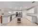 Bright, open kitchen features white cabinetry, granite countertops, and a center island at 25723 S Hawes Rd, Queen Creek, AZ 85142