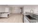 Bright kitchen with granite countertops, stainless sink, and island overlooking dining area at 25723 S Hawes Rd, Queen Creek, AZ 85142