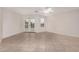 Spacious living room features tile flooring, ceiling fan, and a double-door entry to the backyard at 25723 S Hawes Rd, Queen Creek, AZ 85142