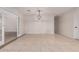Open living room with tile flooring and decorative hanging light fixture at 25723 S Hawes Rd, Queen Creek, AZ 85142