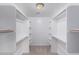 Large walk-in closet with white shelving and hanging rods at 25723 S Hawes Rd, Queen Creek, AZ 85142
