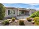 Backyard of the house with a covered patio area and desert landscaping at 26616 W Quail Ave, Buckeye, AZ 85396