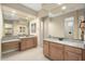 Bathroom vanity and sink with a granite countertop and many mirrors with views of the standing shower at 26616 W Quail Ave, Buckeye, AZ 85396