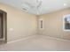 Large bedroom with a ceiling fan, neutral carpet and natural light from the shuttered windows at 26616 W Quail Ave, Buckeye, AZ 85396