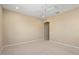 Spacious bedroom with neutral carpet and a ceiling fan; view of doorway to adjacent room at 26616 W Quail Ave, Buckeye, AZ 85396