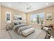 Bright bedroom featuring natural light from two windows, ceiling fan, and neutral decor for a calming space at 26616 W Quail Ave, Buckeye, AZ 85396