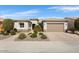 Inviting single-story home showcases a two-car garage, desert landscaping, and a covered entrance for added curb appeal at 26616 W Quail Ave, Buckeye, AZ 85396