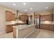 Stylish kitchen with a center island, pendant lighting, and stainless steel appliances at 26616 W Quail Ave, Buckeye, AZ 85396