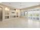 Spacious living area with neutral palette, built-in shelving, tile floors, and sliding doors leading to the outdoor space at 26616 W Quail Ave, Buckeye, AZ 85396