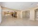 Bright living room boasting neutral paint, wood-look tile floors, and an open concept layout at 26616 W Quail Ave, Buckeye, AZ 85396