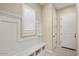 Mud room with white wainscoting, a built-in bench, and a decorative window at 26616 W Quail Ave, Buckeye, AZ 85396