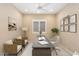 Home office featuring a ceiling fan, large window, and desk area at 26616 W Quail Ave, Buckeye, AZ 85396