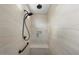 Standing shower with a wall-mounted shower head, handheld sprayer, built-in niche and bench at 26616 W Quail Ave, Buckeye, AZ 85396