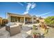 Expansive backyard featuring a built-in BBQ area, covered patio, and desert landscape perfect for outdoor enjoyment at 26828 W Piute Ave, Buckeye, AZ 85396