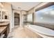 Bathroom featuring a soaking tub, walk-in shower, and view of a walk-in closet at 26828 W Piute Ave, Buckeye, AZ 85396