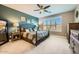 Stylish bedroom featuring accent wall, plush bedding, and large window with shutters at 26828 W Piute Ave, Buckeye, AZ 85396