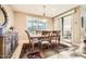 Elegant dining room with natural light, stylish furniture, and a view of the outdoor patio at 26828 W Piute Ave, Buckeye, AZ 85396