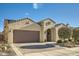 Charming single-story stucco home featuring a paved driveway, desert landscaping, and a two-car garage at 26828 W Piute Ave, Buckeye, AZ 85396