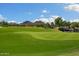Lush green golf course with scenic mountain views, providing a picturesque backdrop for recreational activities at 26828 W Piute Ave, Buckeye, AZ 85396