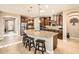 Modern kitchen with a granite island, stainless steel appliances, wood cabinets, and pendant lighting at 26828 W Piute Ave, Buckeye, AZ 85396