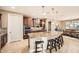 Beautiful kitchen featuring a large island with seating, stainless appliances, wood cabinets, and stylish pendant lights at 26828 W Piute Ave, Buckeye, AZ 85396