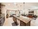 Open-concept kitchen featuring a large island, granite countertops, and stainless steel appliances at 26828 W Piute Ave, Buckeye, AZ 85396