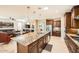 Spacious kitchen with granite countertops, stainless steel appliances, and a large island overlooking the living area at 26828 W Piute Ave, Buckeye, AZ 85396