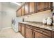 Well-organized laundry room with granite countertops and ample cabinet space for efficient storage at 26828 W Piute Ave, Buckeye, AZ 85396